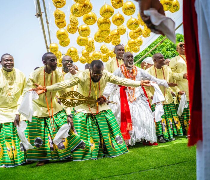 Okere community dancers dancing before Ogiame Atuwatse III